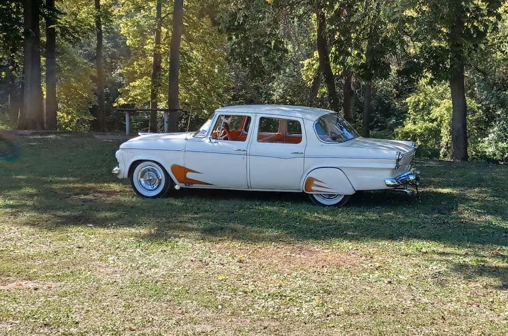 an old white car with flames painted on it