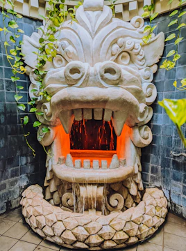 a fountain with a dragon head on top of it