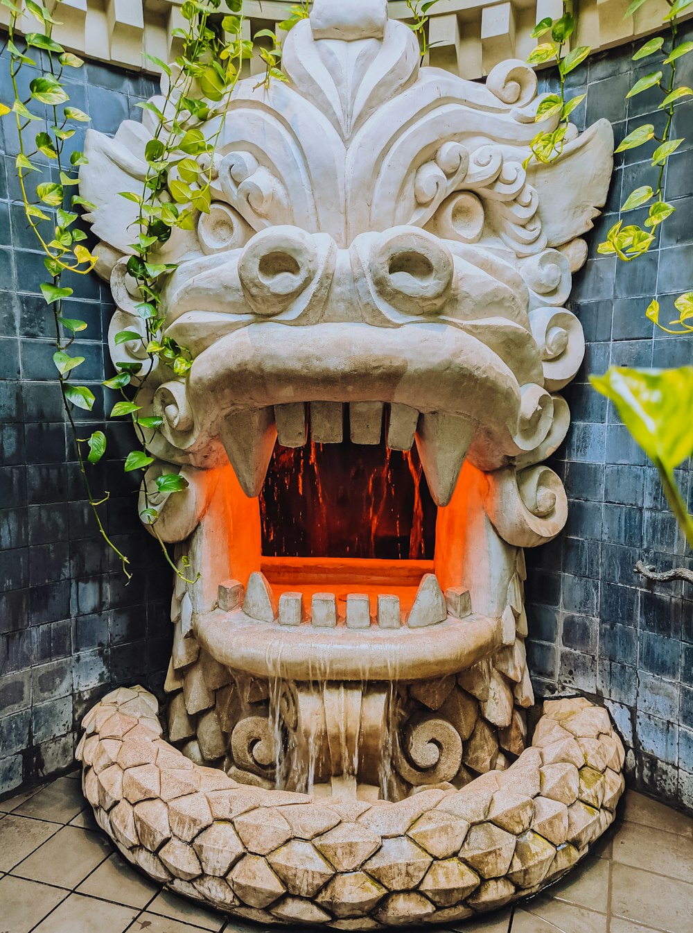 a fountain with a dragon head on top of it