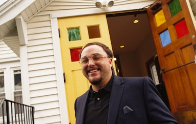 Smiling real estate agent handing keys to happy new homeowners.