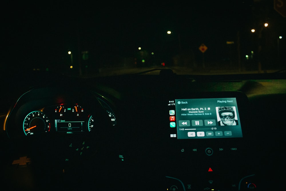 the dashboard of a car in the dark