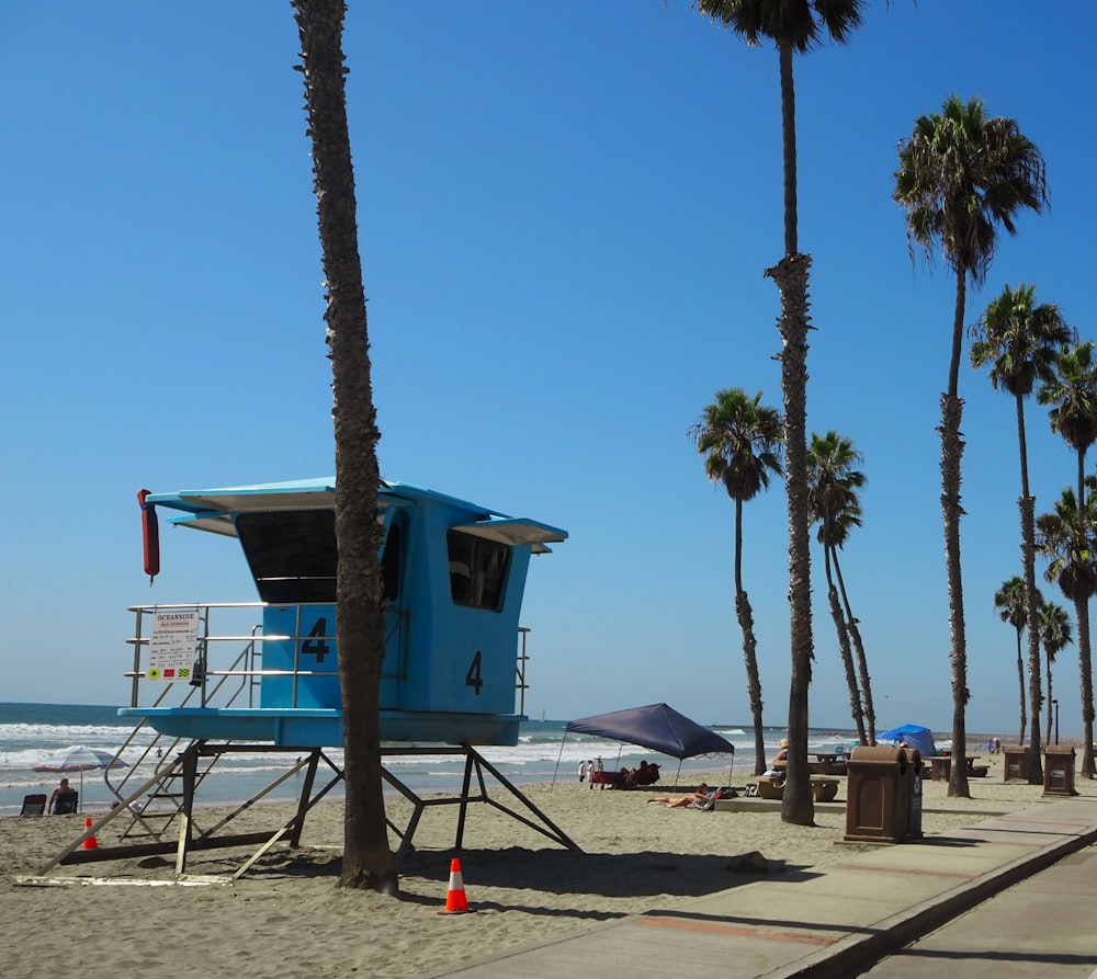 a lifeguard stand on a beach with palm trees