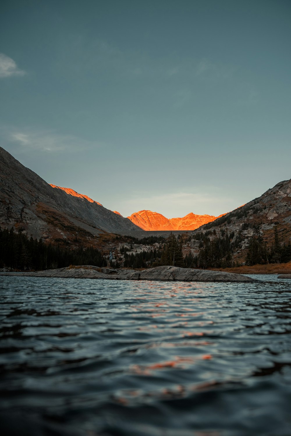 a lake with mountains in the background