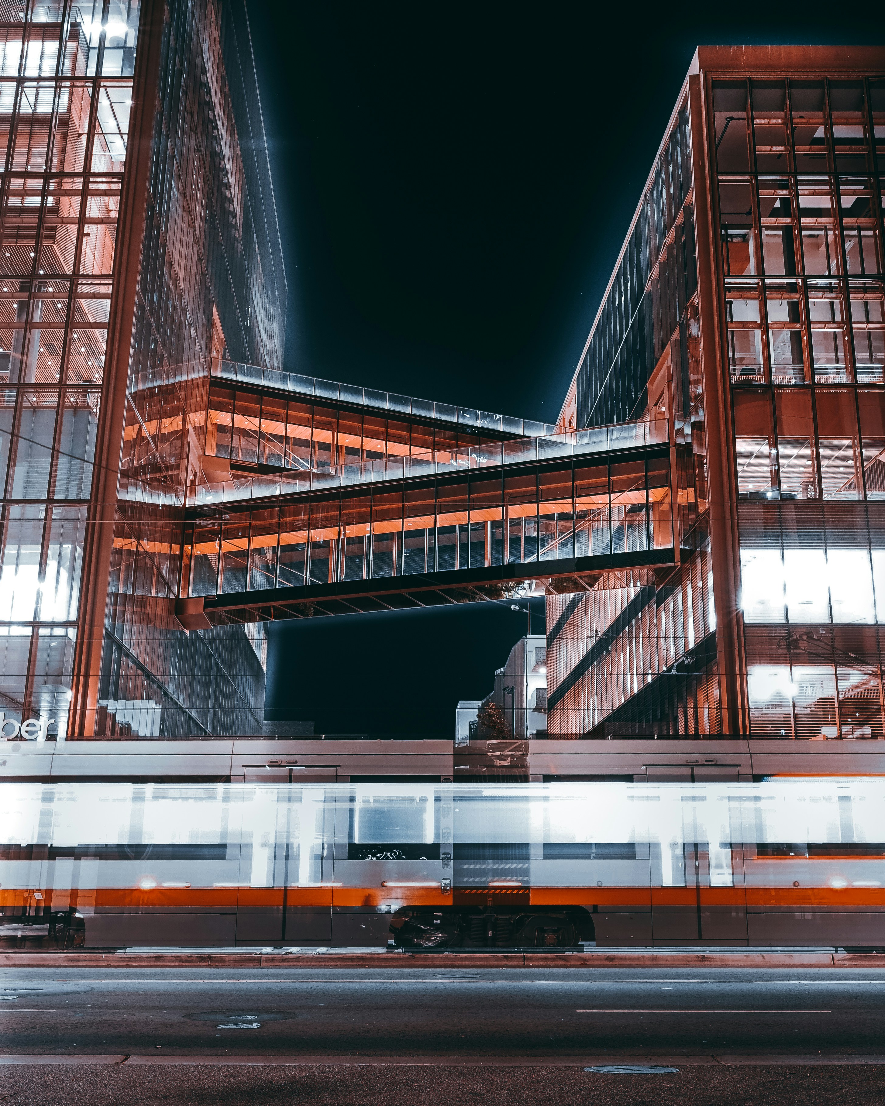 a train passing by a very tall building