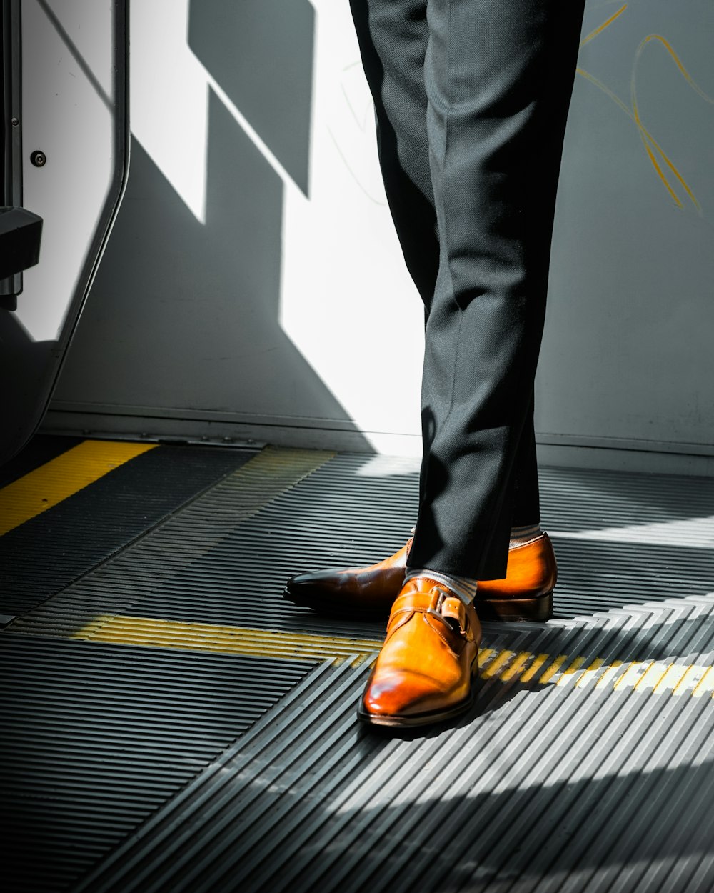 a person wearing orange shoes standing on a ramp