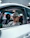 a man sitting in a car wearing a hat