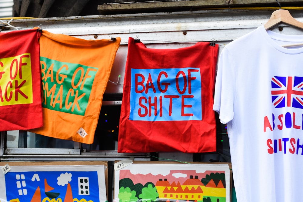 a bunch of flags that are on a rack