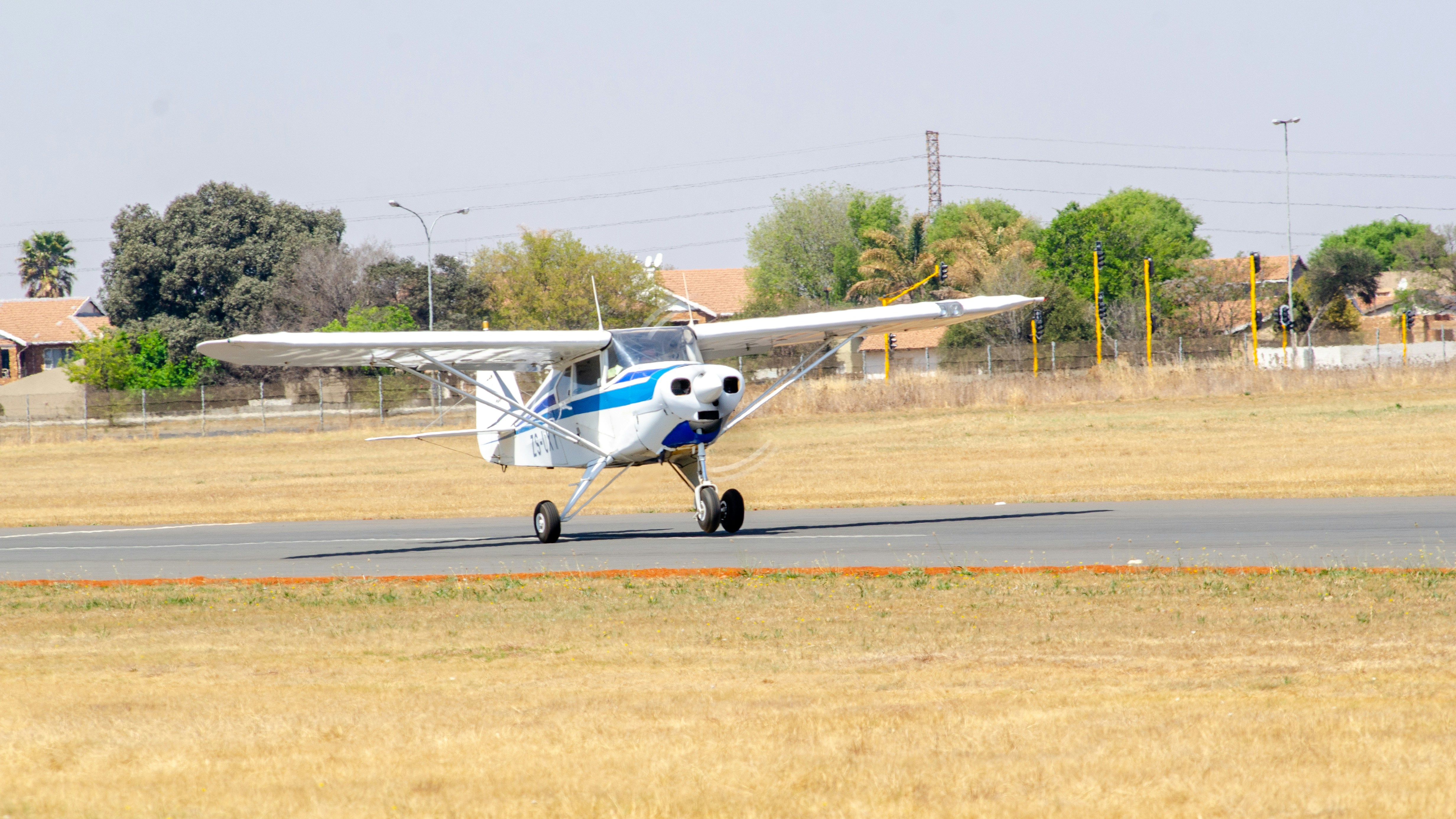 a small airplane is on a runway in a field