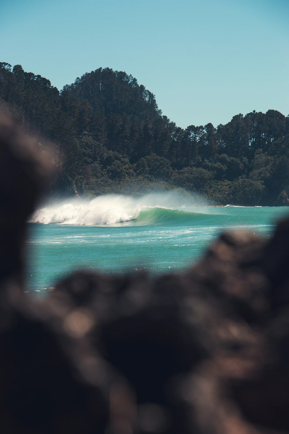 a person riding a wave on top of a surfboard