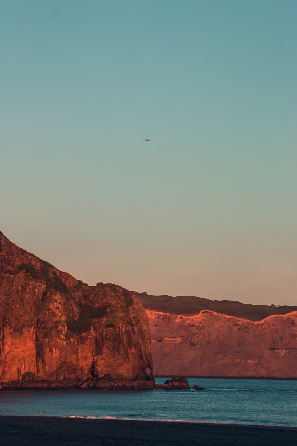 a plane flying over a large body of water