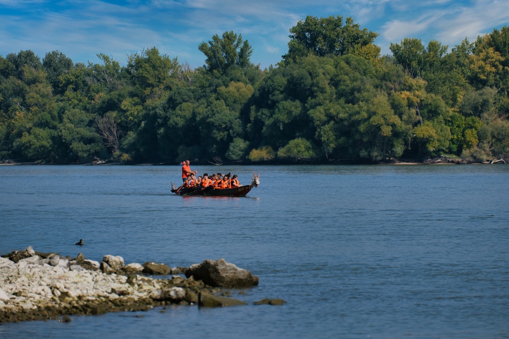 a group of people in a boat on a river