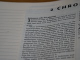 A close-up view of a text from a religious book, focusing on a chapter titled '2 Chronicles'. The passage 'Solomon asks for wisdom' is highlighted, and the text discusses Solomon's establishment over his kingdom and his request for wisdom from God. The page includes numbered sections and is written in a formal, structured format.