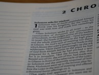 A close-up view of a text from a religious book, focusing on a chapter titled '2 Chronicles'. The passage 'Solomon asks for wisdom' is highlighted, and the text discusses Solomon's establishment over his kingdom and his request for wisdom from God. The page includes numbered sections and is written in a formal, structured format.