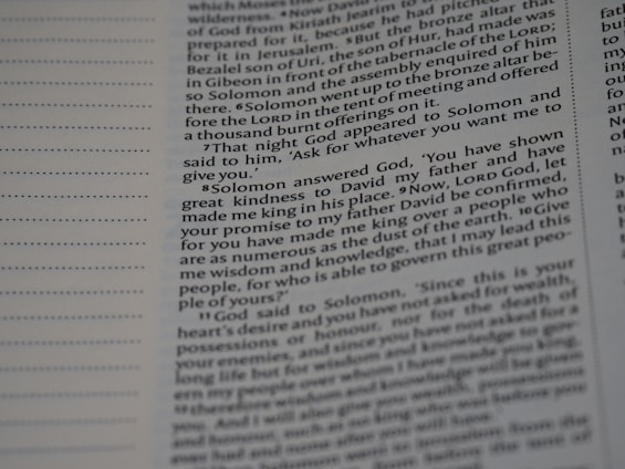 A close-up view of a printed page from a book, focusing on a passage containing text about Solomon and God. The text is neatly organized in columns with some bold headings and varying font sizes. The left side of the image includes dotted lines indicating a margin.