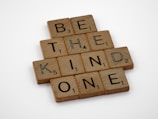 a scrabble of words that spell out be the kind of kind of one
