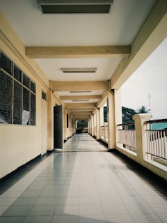 a long hallway lined with windows and doors