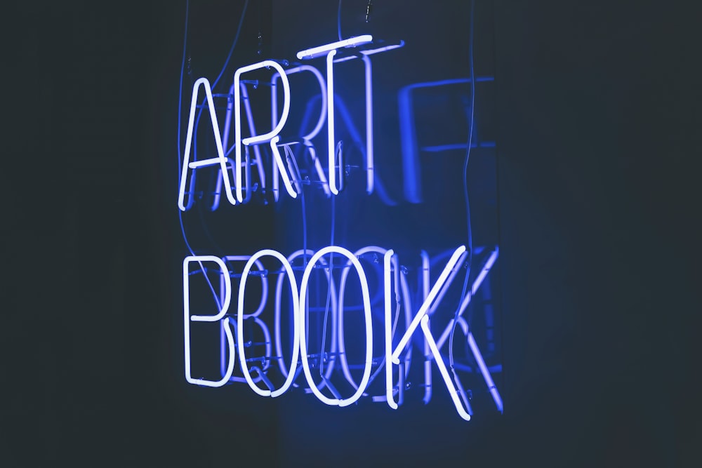 a neon sign that reads art book