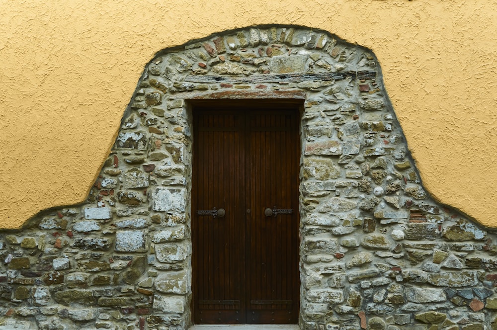 a stone building with a wooden door and window