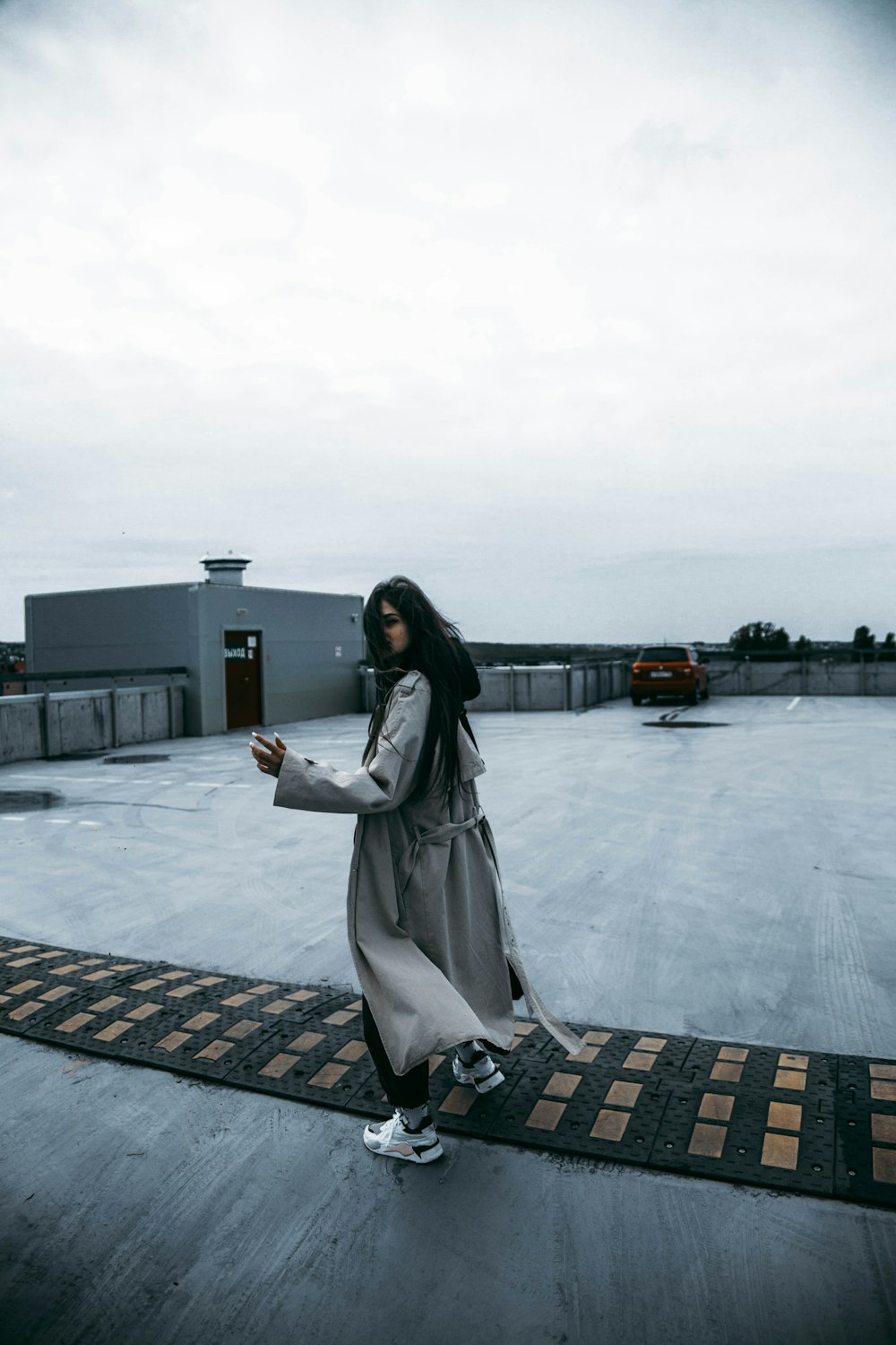 a woman standing on a rug looking at her cell phone