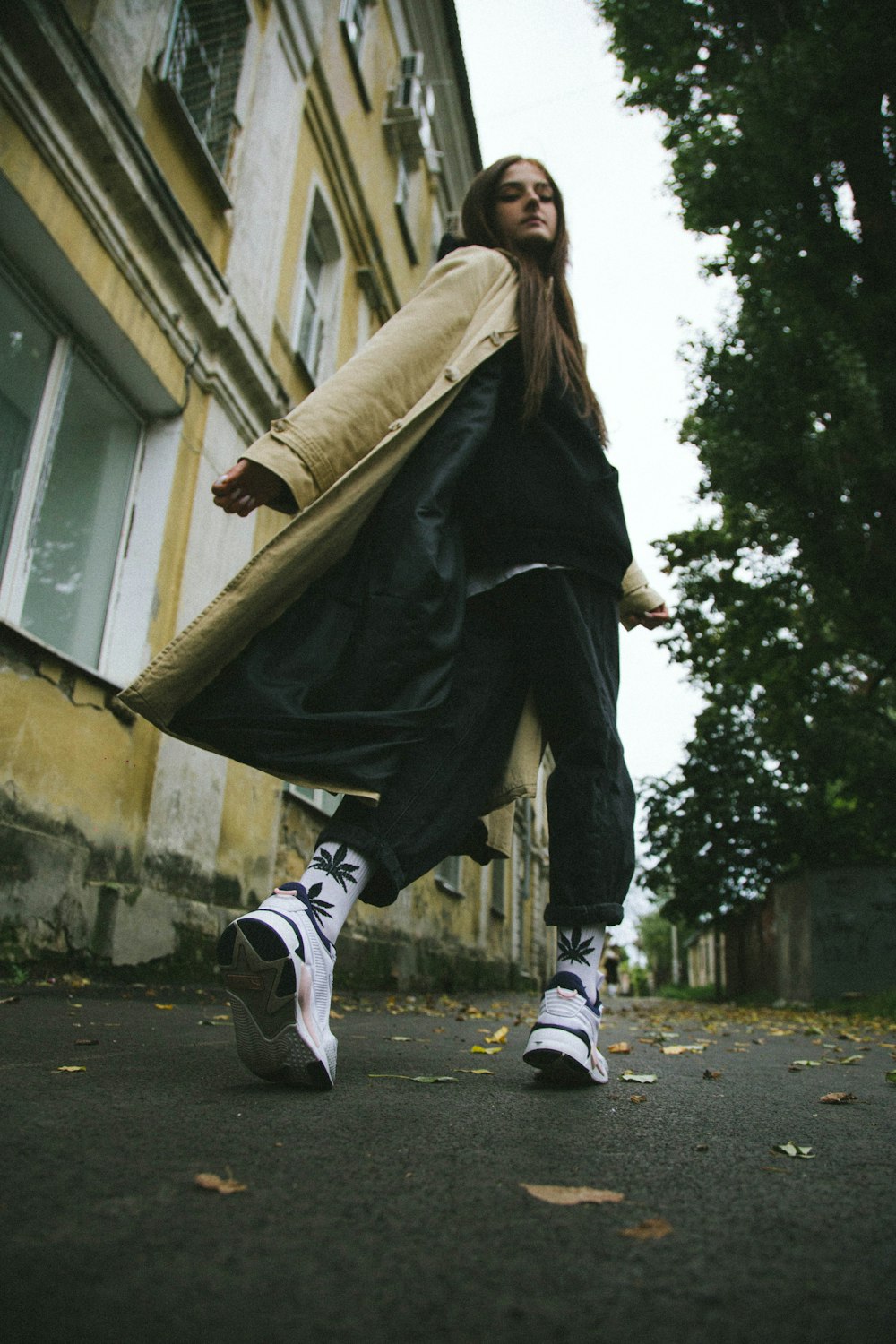 a woman is walking down the street carrying a large bag