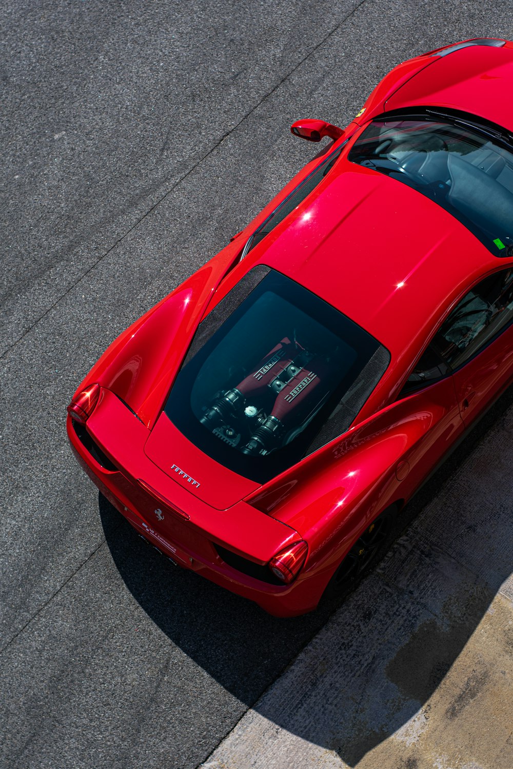 a red sports car driving down a race track