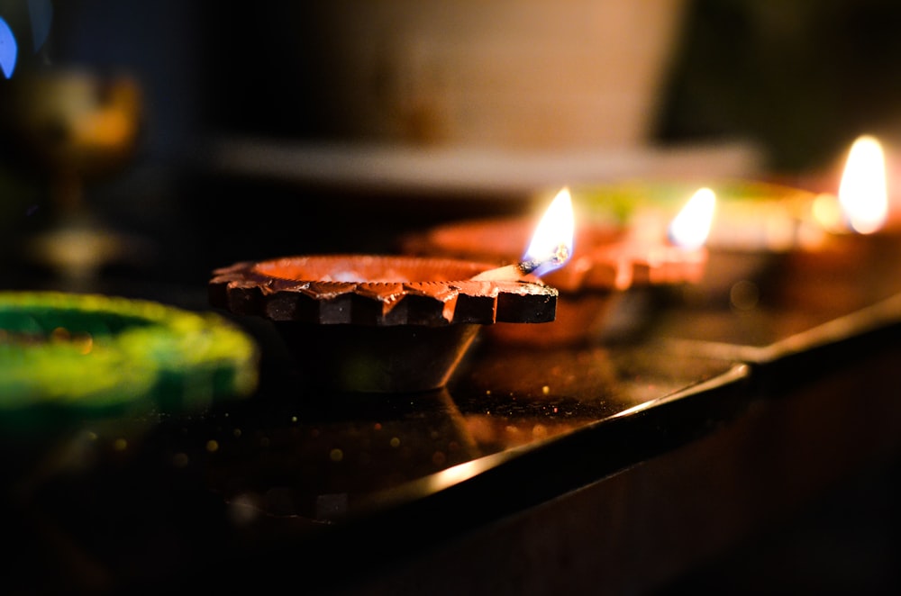 a row of lit candles sitting on top of a table