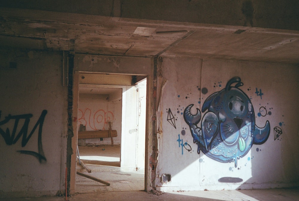 an empty room with graffiti on the walls