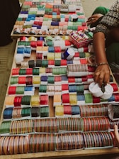 a table topped with lots of different colored spools of thread