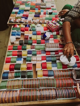 a table topped with lots of different colored spools of thread