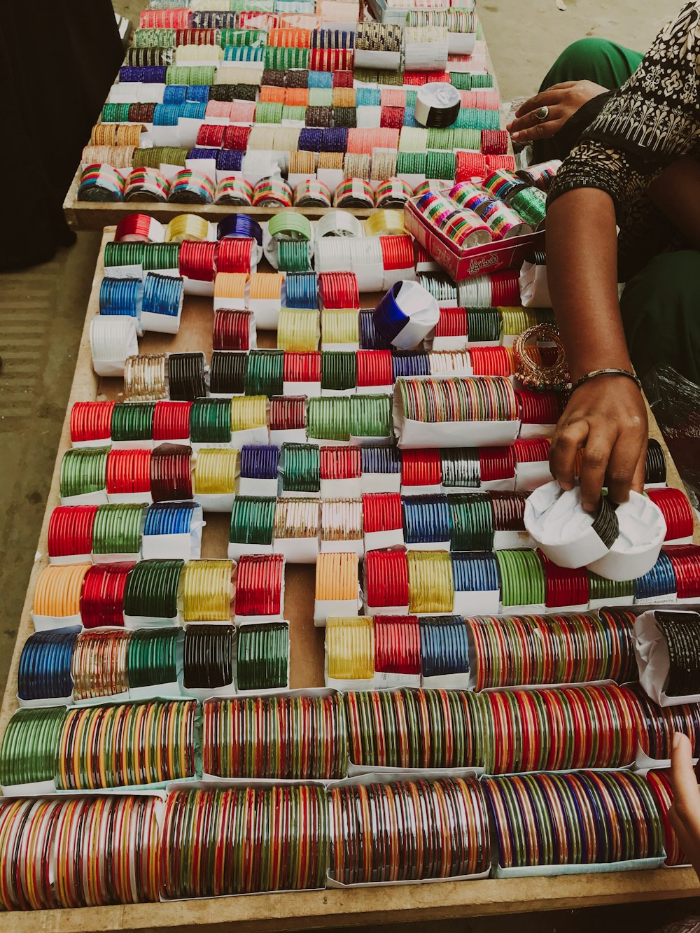 a table topped with lots of different colored spools of thread