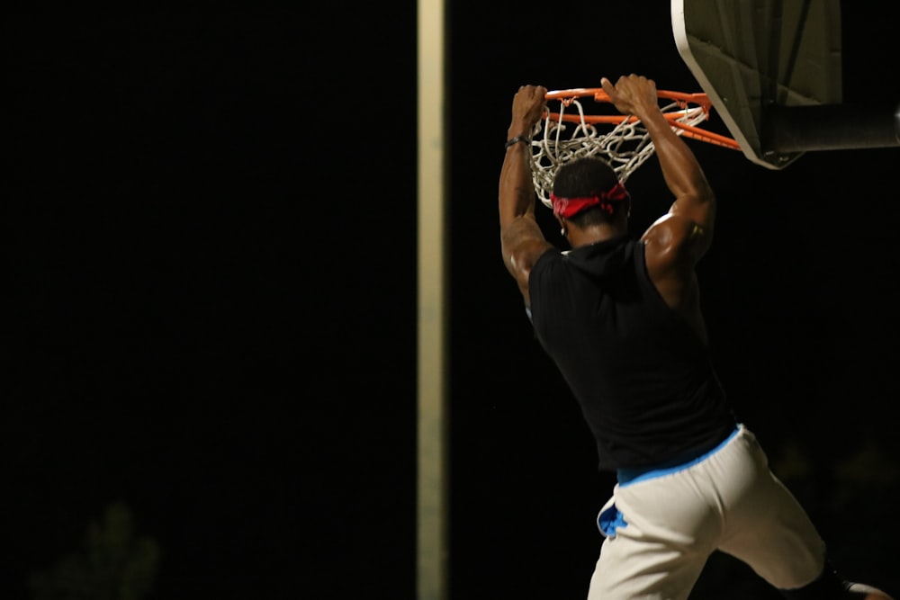 a man dunking a basketball into a hoop