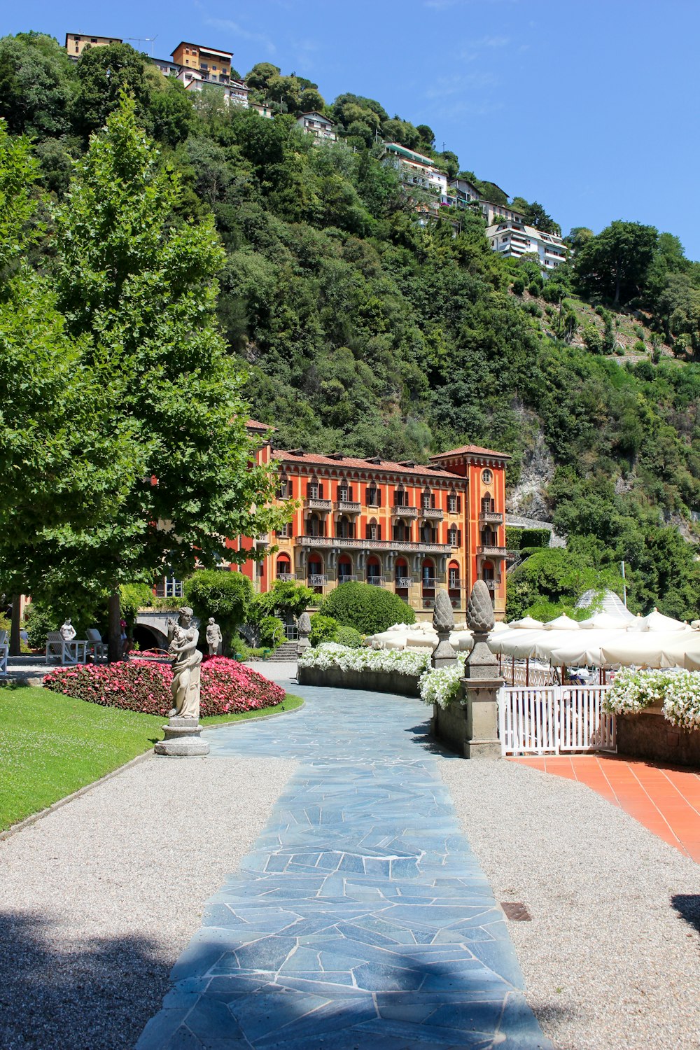 a large building sitting on top of a lush green hillside