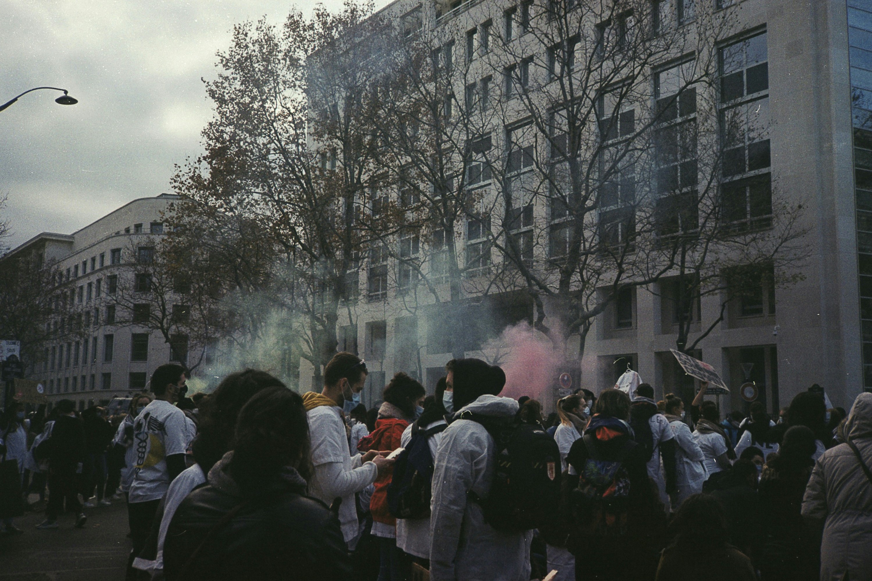 a crowd of people standing around a building