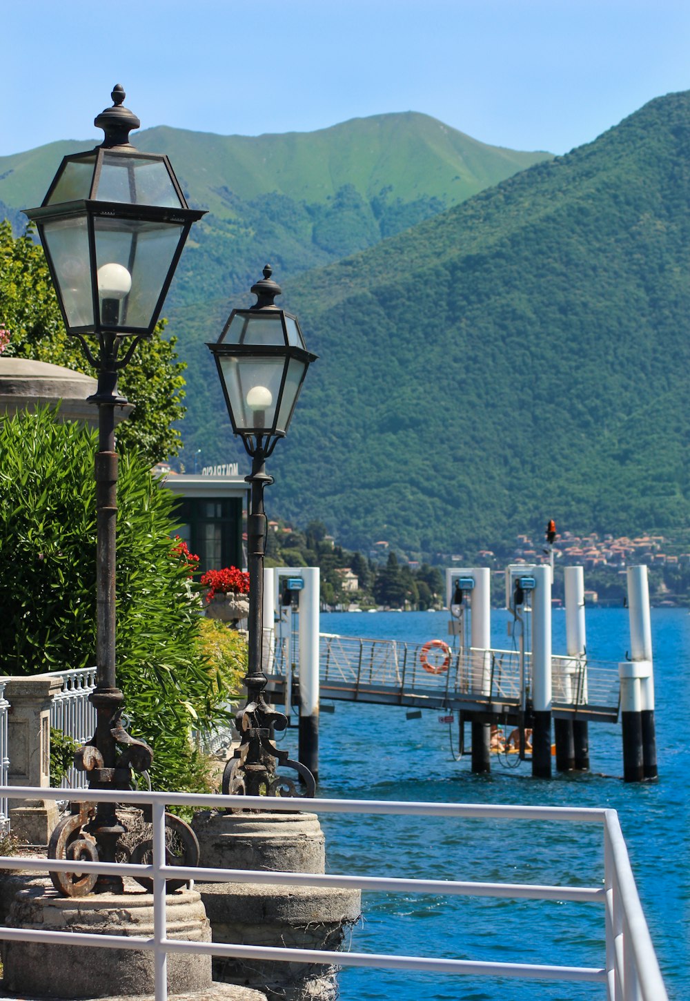 a lamp post next to a body of water