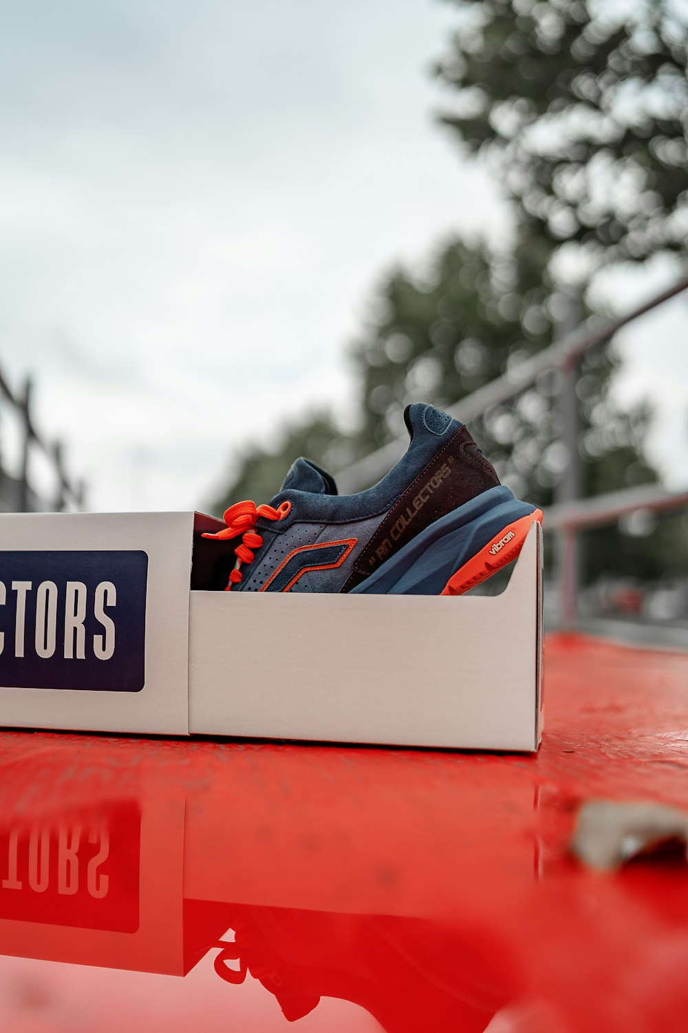 a pair of shoes sitting on top of a red table