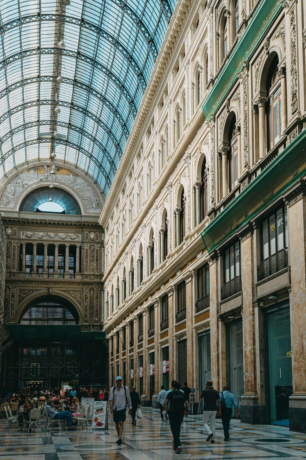 a group of people walking through a large building