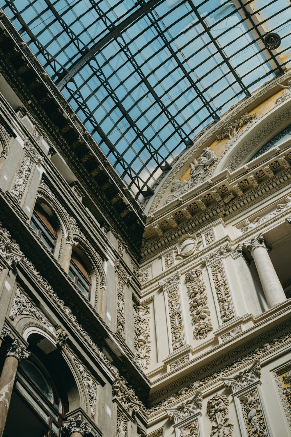 a tall building with a glass roof and a clock