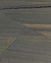3D terrain model of farmland shown on a computer screen in an office setting.