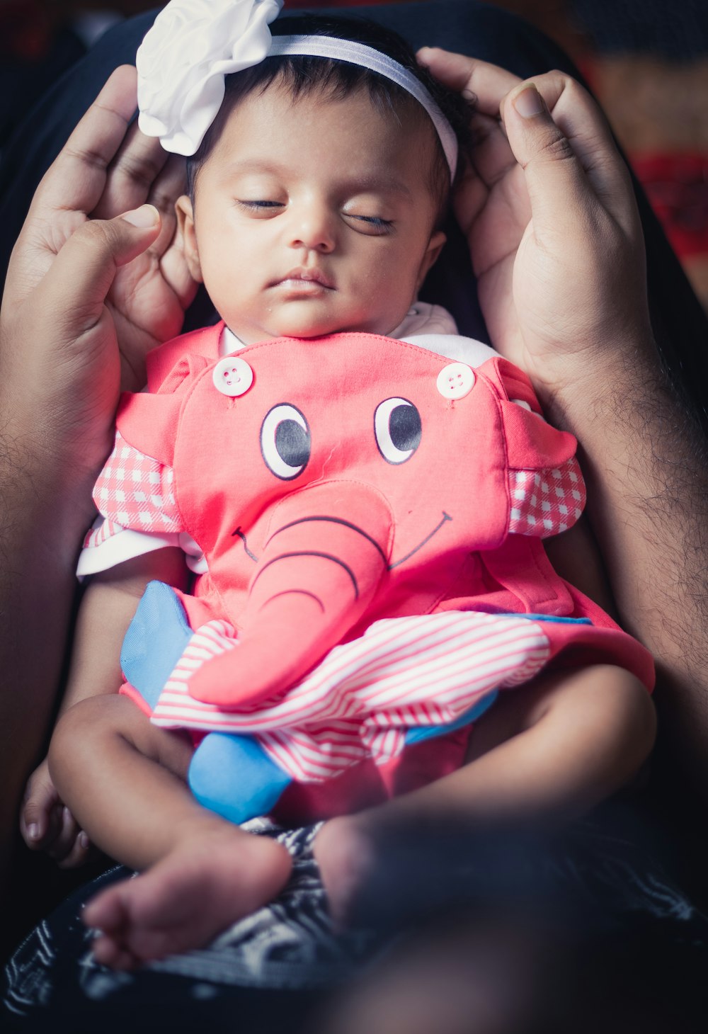 a woman holding a baby in her arms