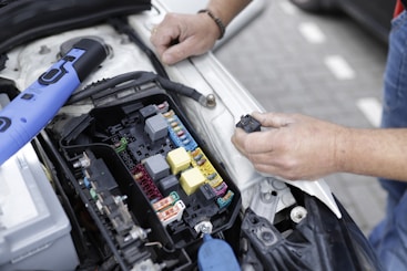 a man is working on a car's engine