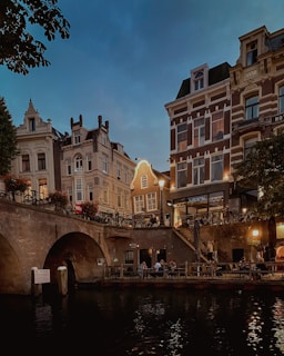 a bridge over a body of water next to tall buildings