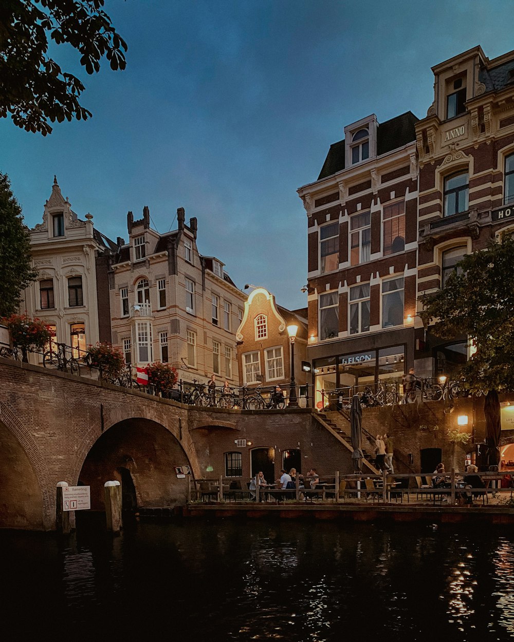 a bridge over a body of water next to tall buildings