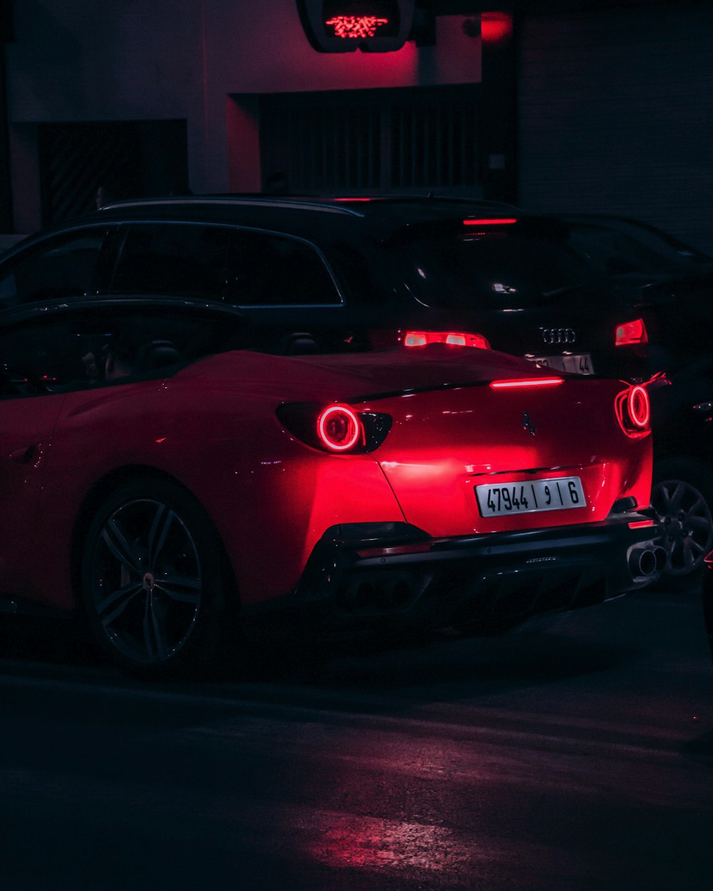 a red sports car parked in a parking lot