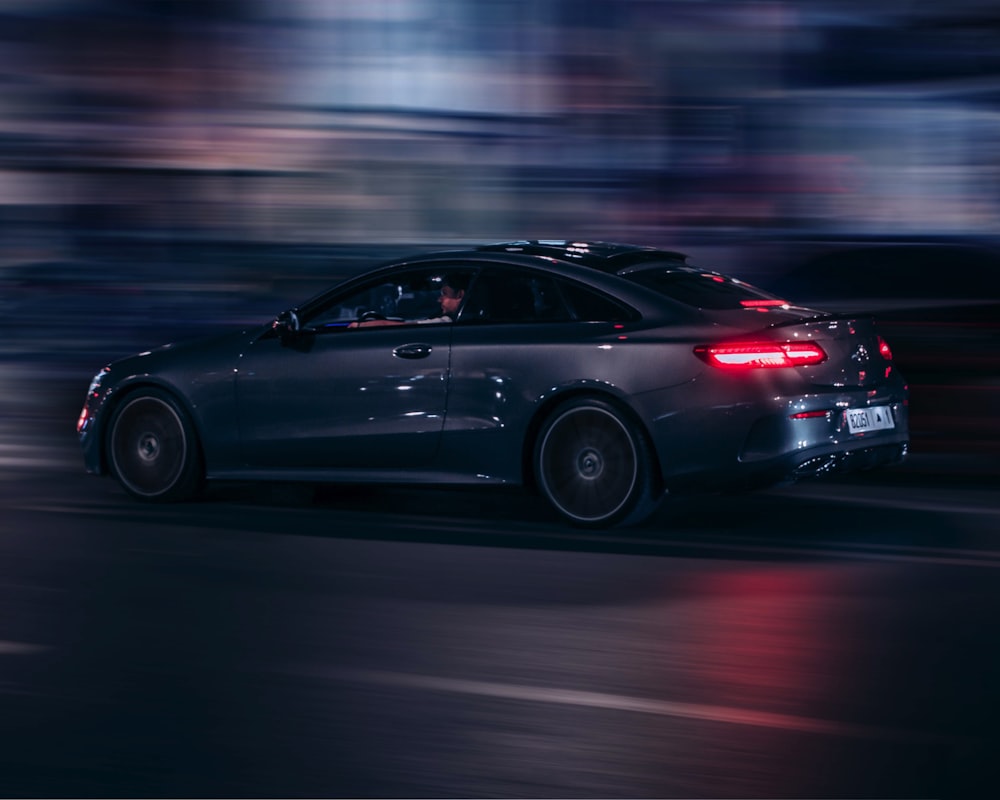 a car driving down a city street at night