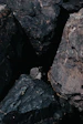 a pile of black rocks sitting next to each other