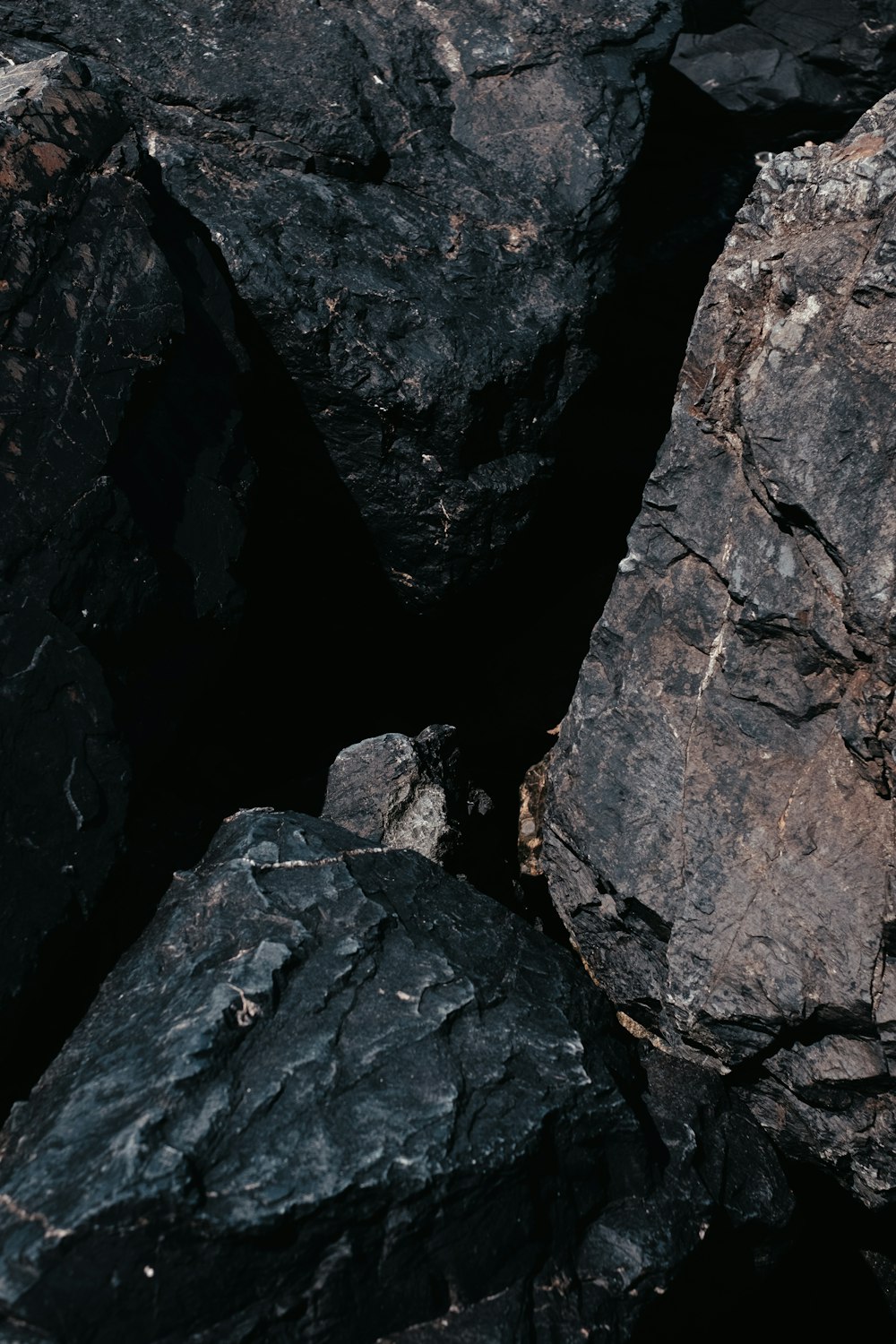 a pile of black rocks sitting next to each other