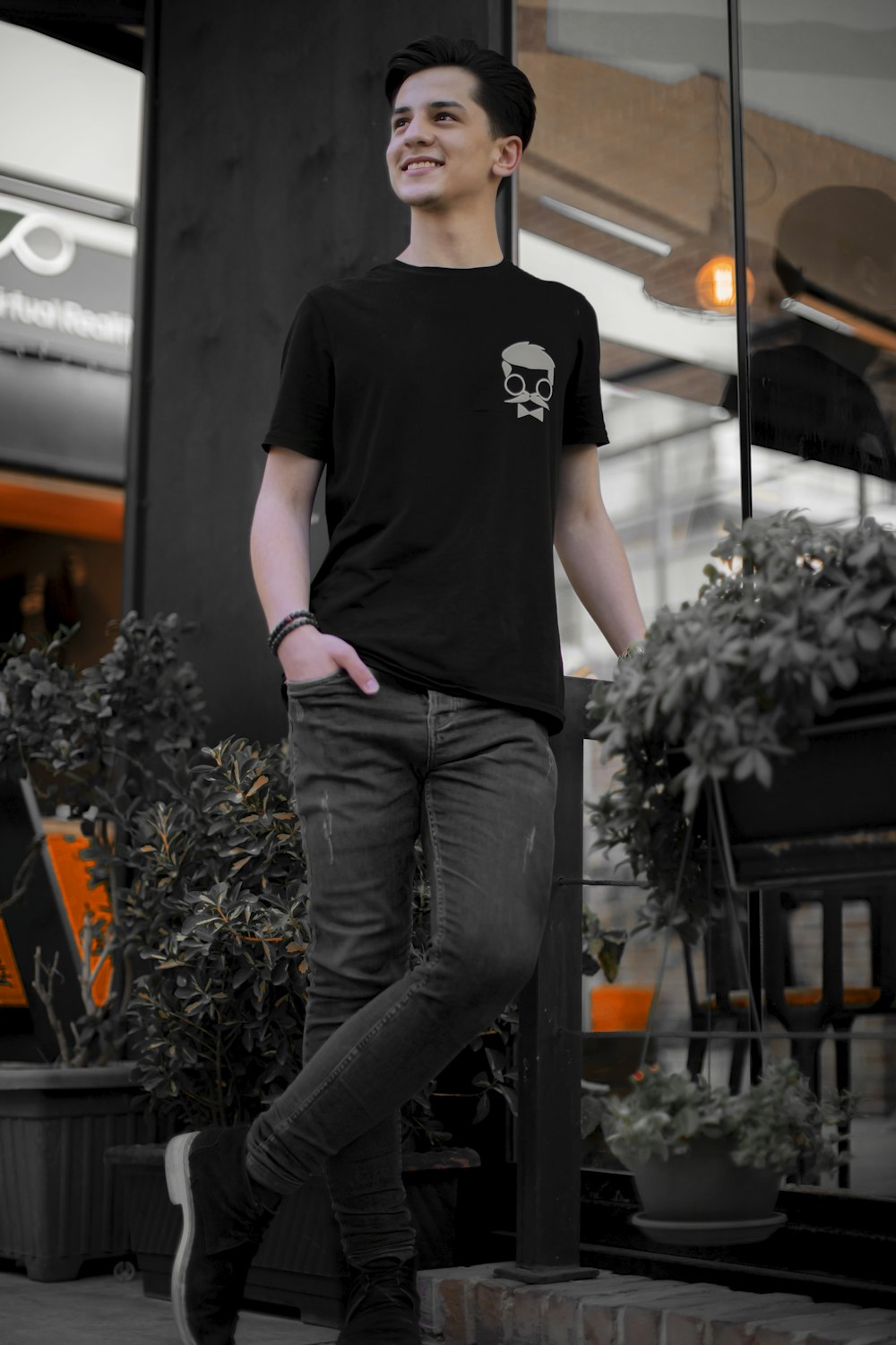 a young man is standing on a skateboard