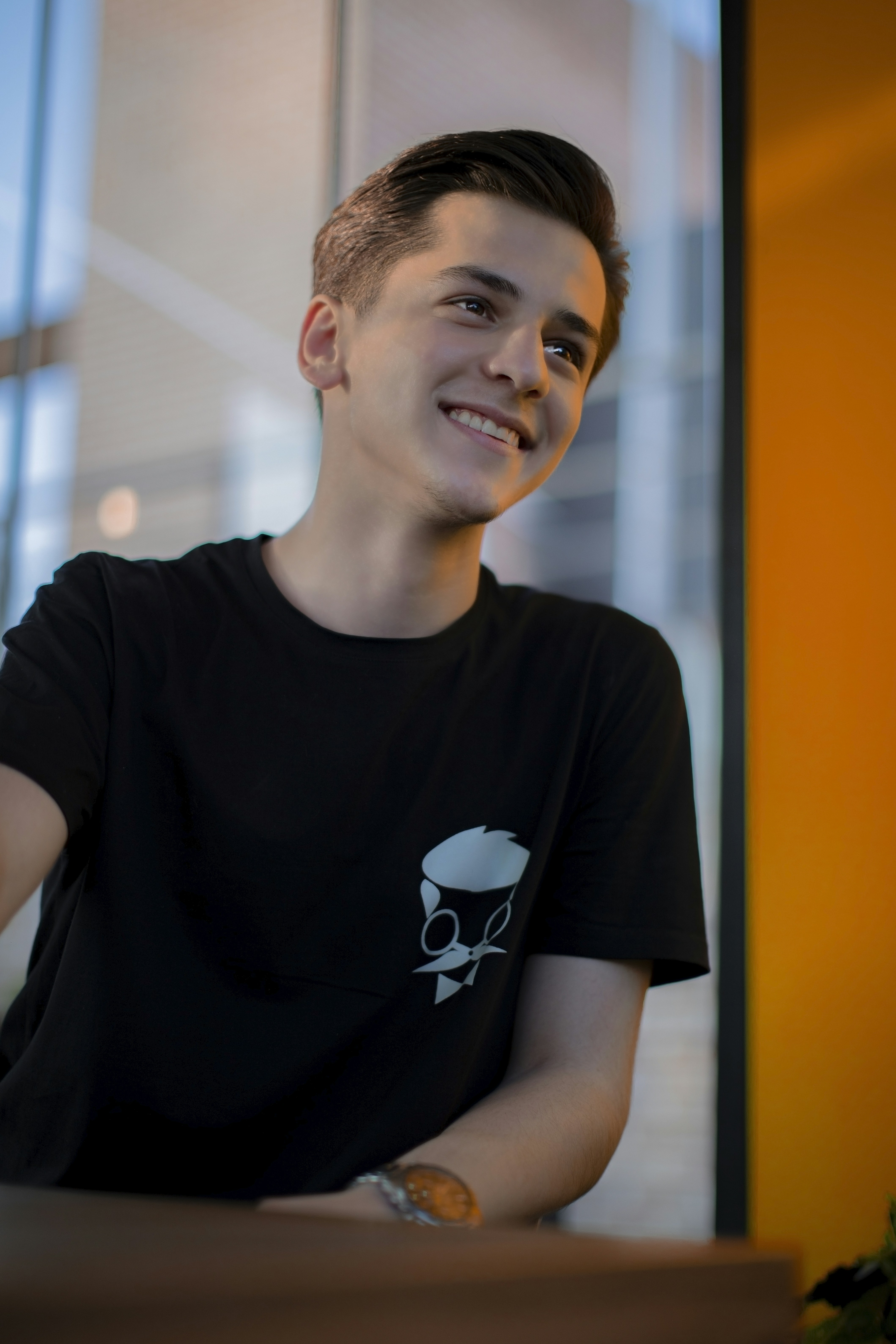 a man sitting at a table with a smile on his face