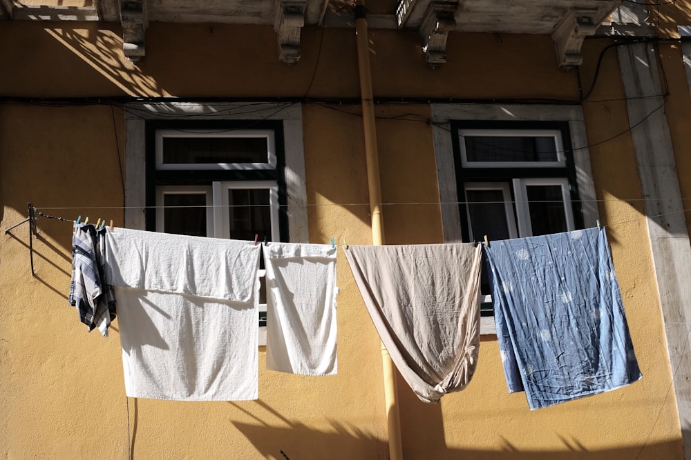 clothes hanging on a clothes line outside of a building