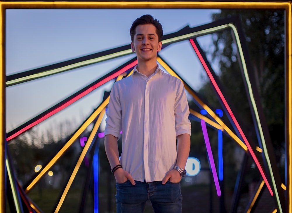 a man standing in front of a colorful structure